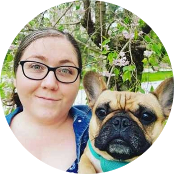 A woman and her dog are posing for the camera.