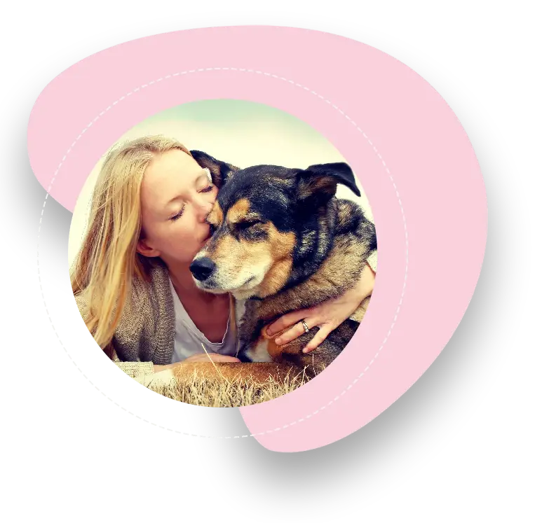 A woman kissing her dog on the cheek.